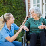 Portrait of community health nurse with patient