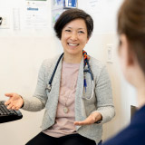 Portrait of female doctor with patient