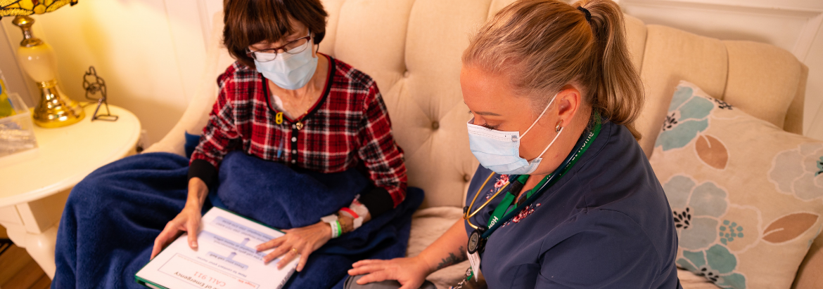 nurse and patient looking at chart on a couch