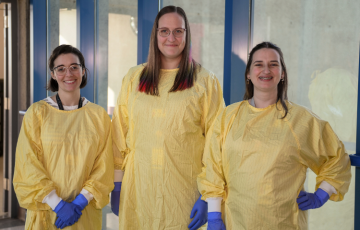 Three healthcare workers wearing reusable gowns