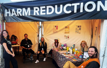 Rifflandia festival harm reduction team sitting together in festival tent