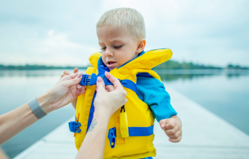 Child with personal floatation device