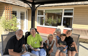 group of people sitting outside smiling