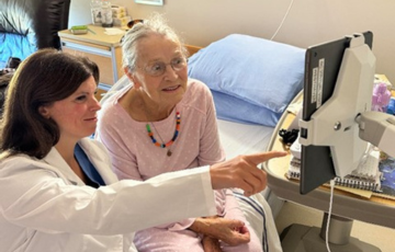 long term care patient and care provider watching screen