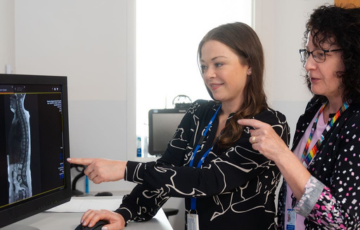 two people looking at medical image on a computer screen