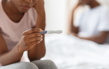 woman looking at pregnancy test